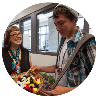Two individuals participate in an indigenous ceremony.