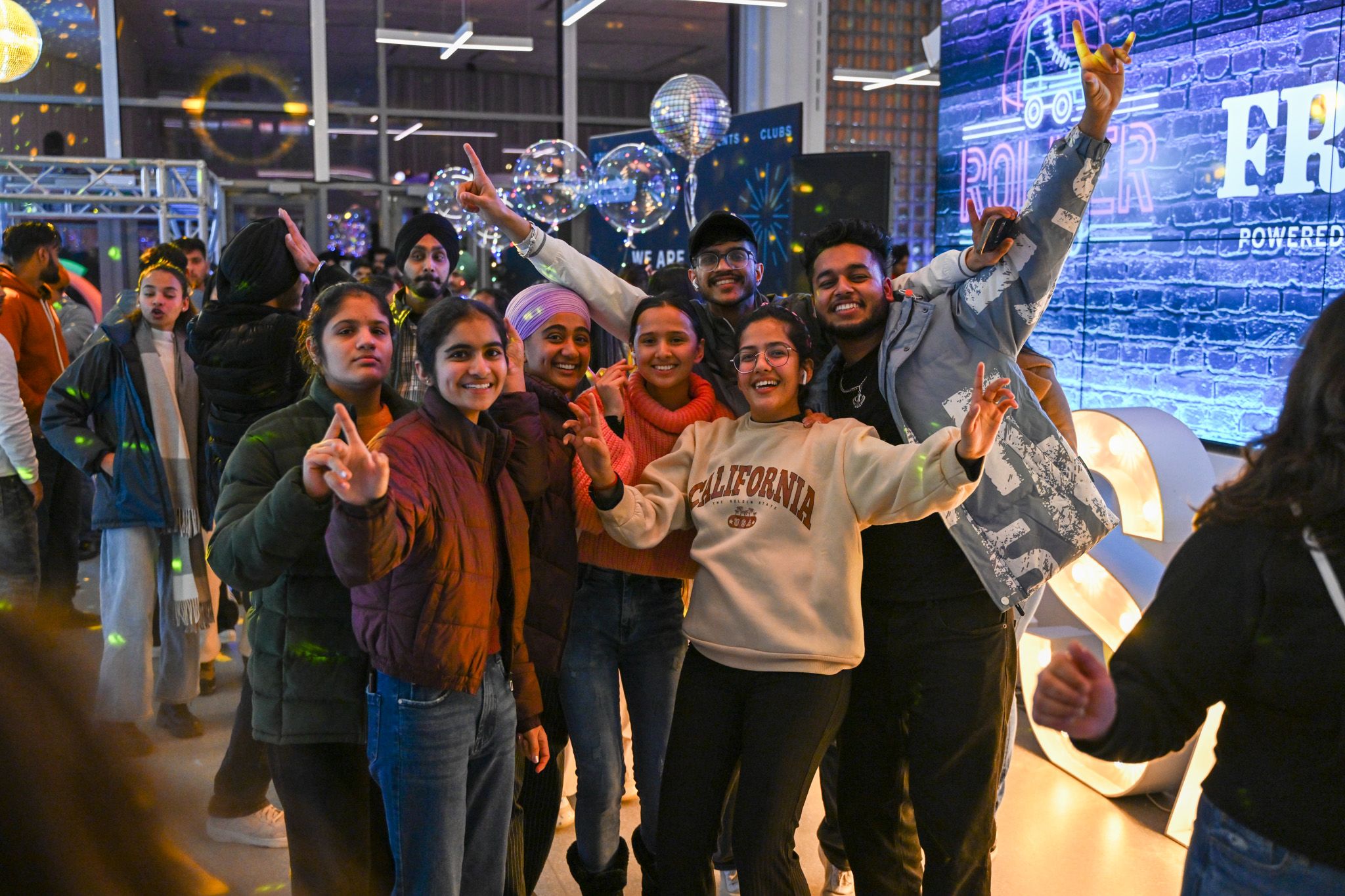 A diverse group of students smiling and posing together.