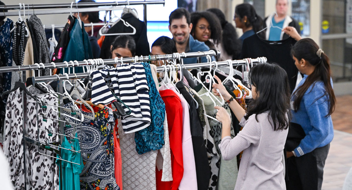 Students browse racks of donated clothing