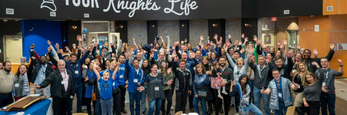 A large group of alumni celebrating in The Core during the ReuKnighted event