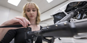 A student working in a lab on a drone.