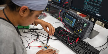 Student working with electronic equipment