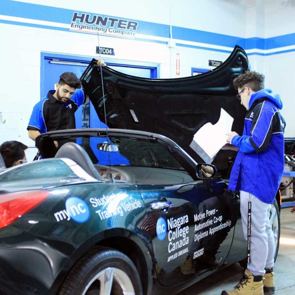 Students work on car