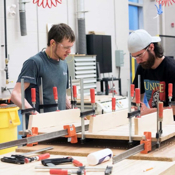 Students work in construction lab on wood project