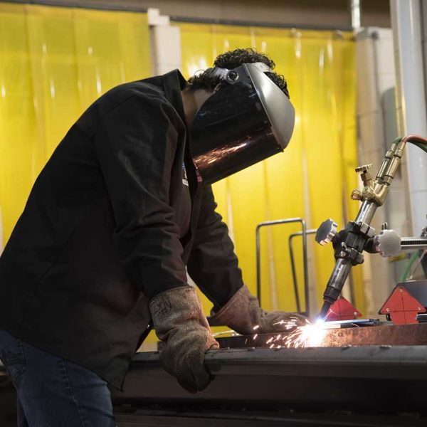 Student welding in lab