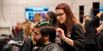 Student cutting hair of male client in NC Teaching Hair Salon.