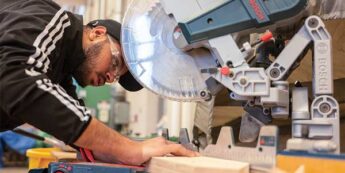 Student working with mitre saw.