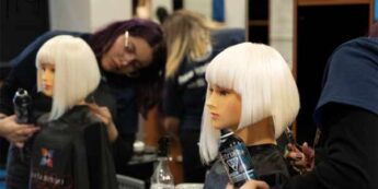 Cutting hair of a wig in a student class.