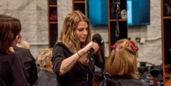 Student cutting hair of a client in the NC Teaching Hair Salon.