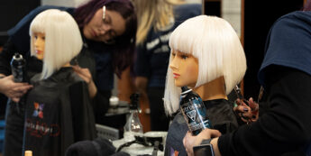 Cutting hair on a wig in a student class.