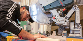 Student working with mitre saw.