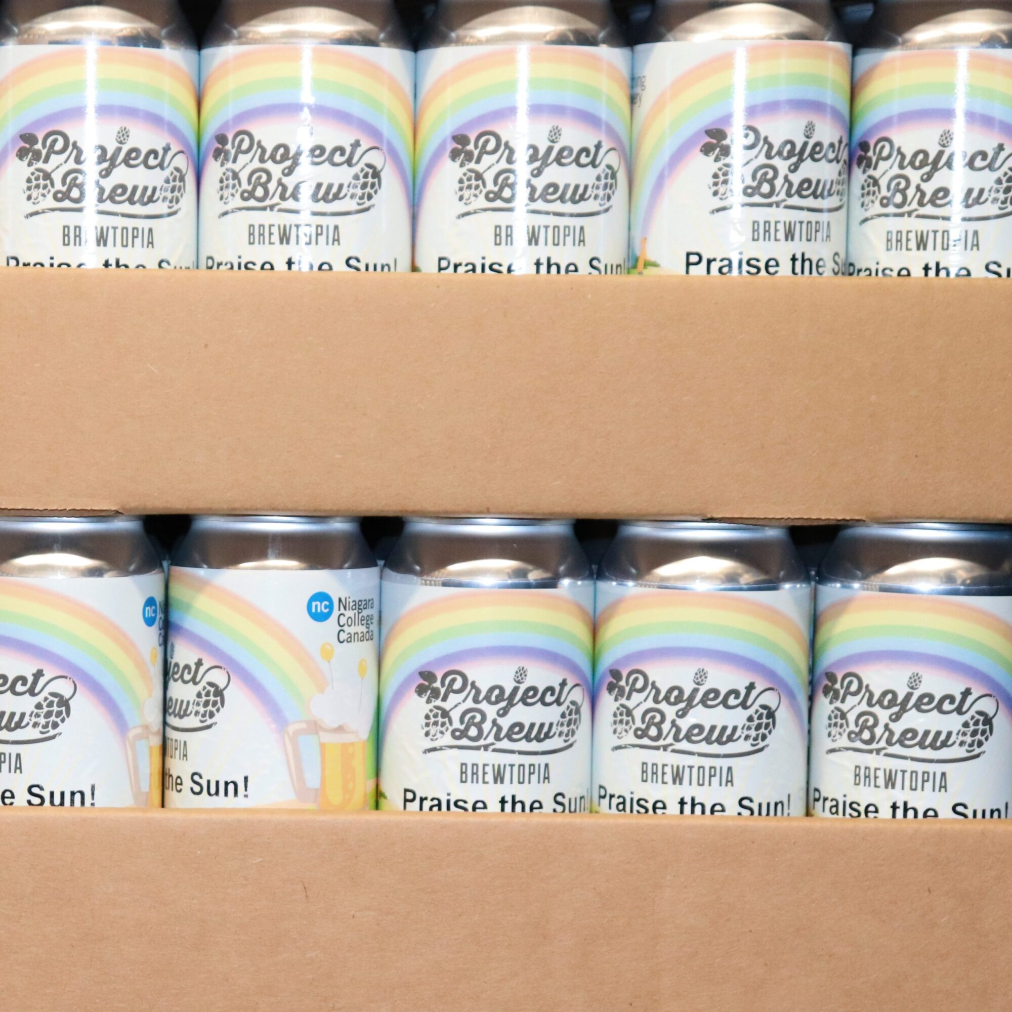 beer cans with a rainbow label stacked in cardboard boxes