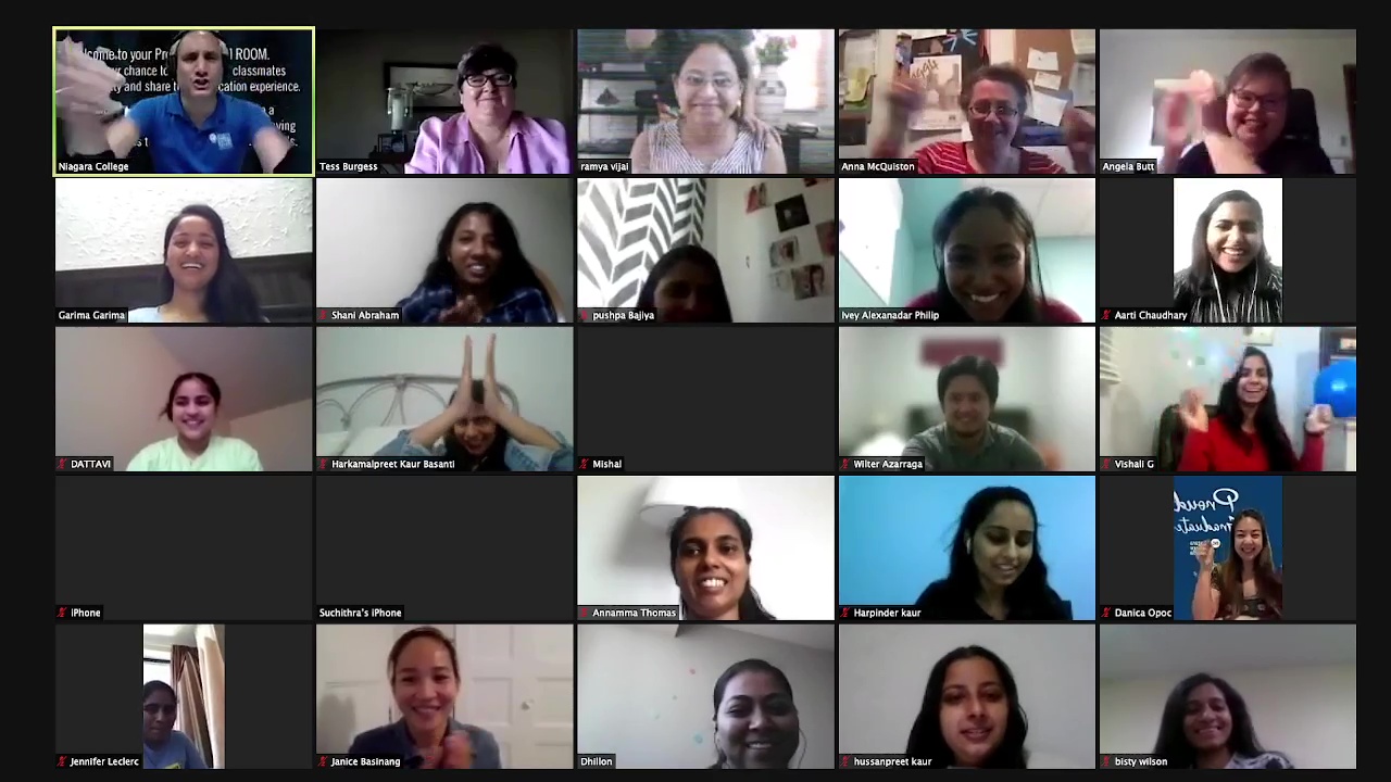 A screen grab of people on a zoom call smiling and looking happy.