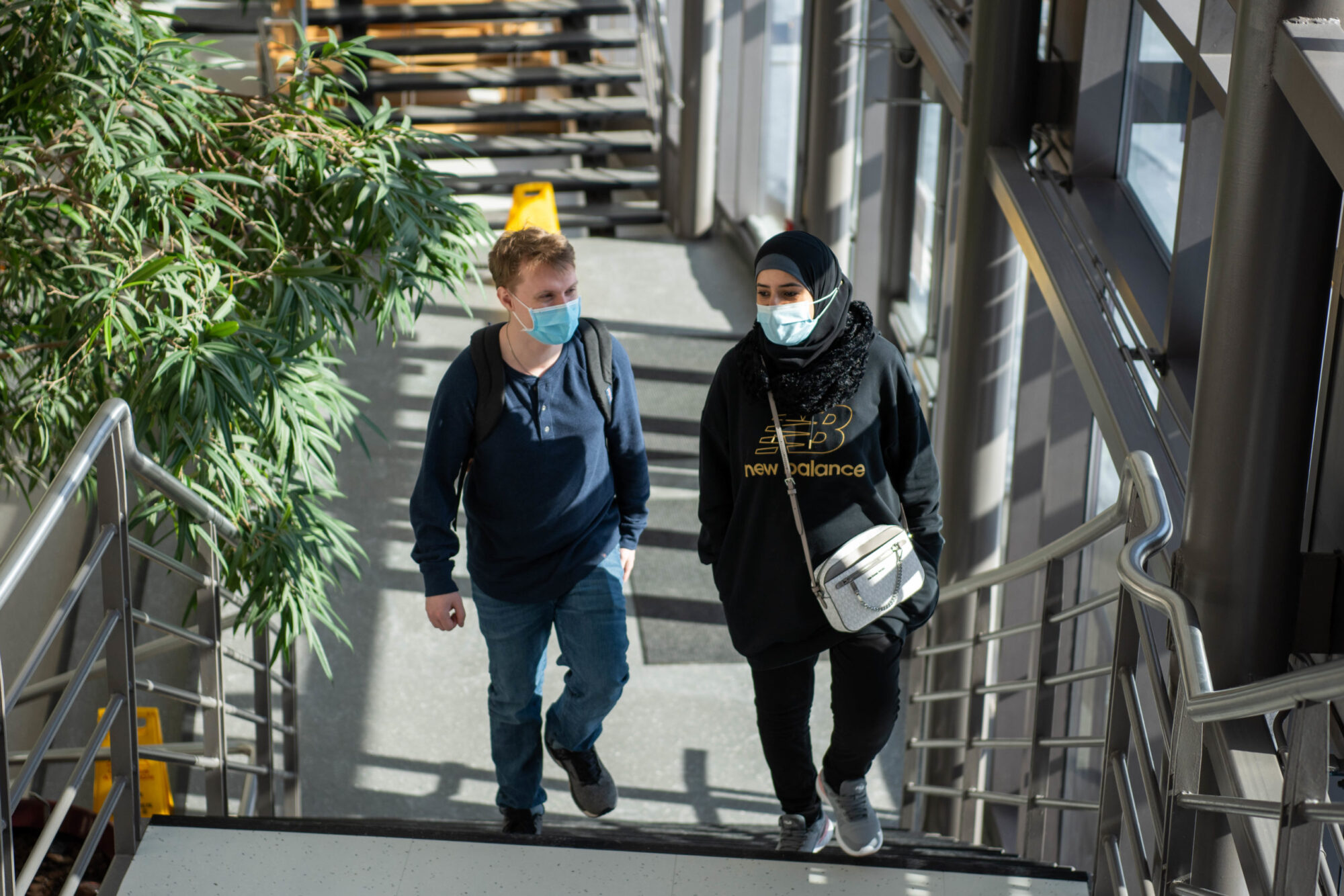 Two students wearing medical-grade masks walk up the stairs at the Daniel J. Patterson Campus in Niagara-on-the-Lake