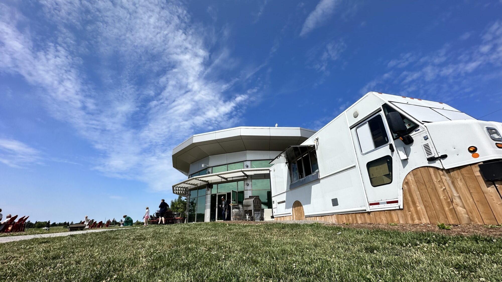 a food truck on the grass beside a building