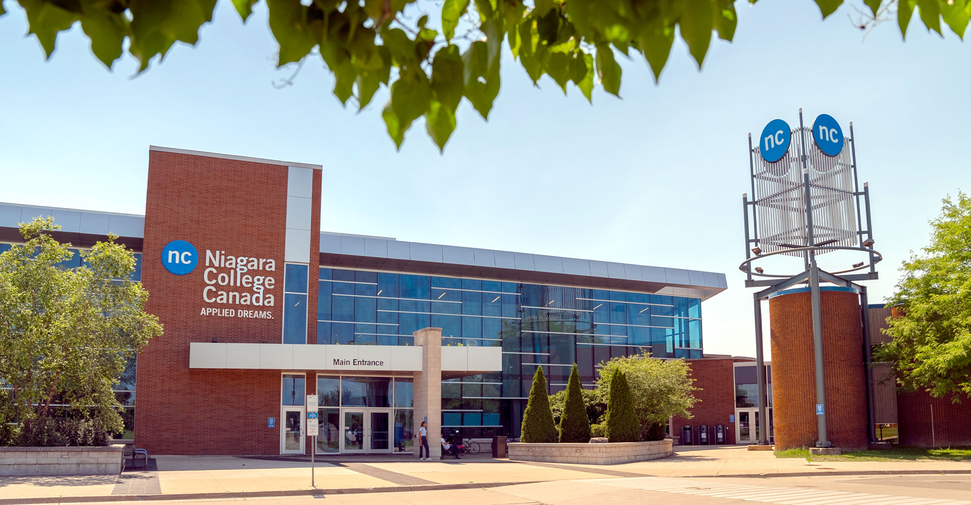 Front elevation of the Welland Campus taken from beneath a tree