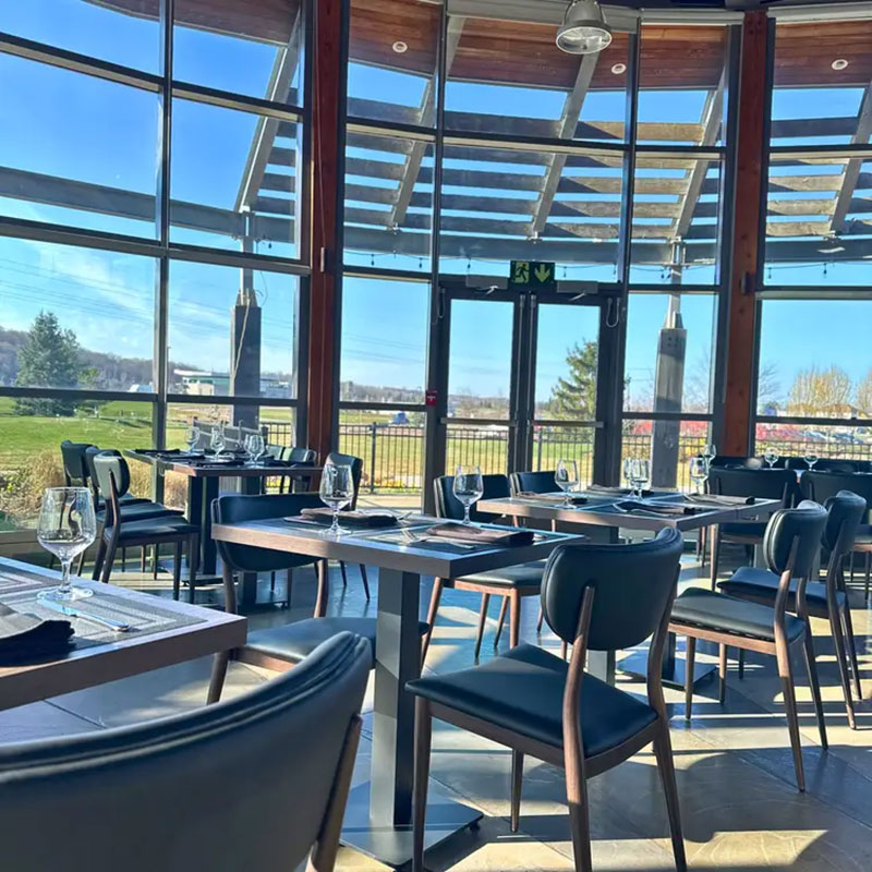 Benchmark Restaurant dining room with large glass wrap around windows