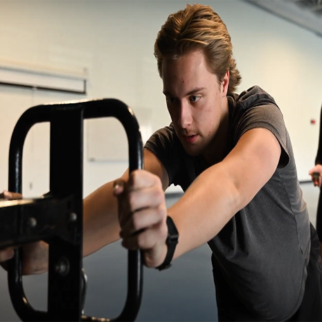 Student working out with a piece of exercise equipment