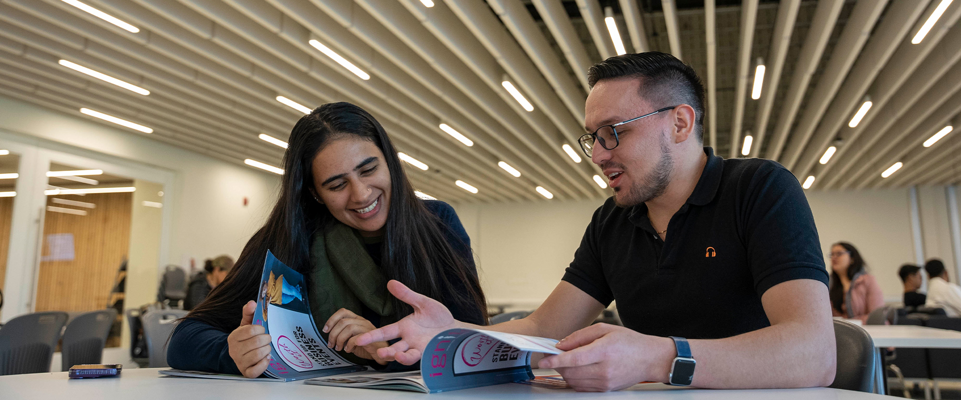 Two students engaged in study at a library