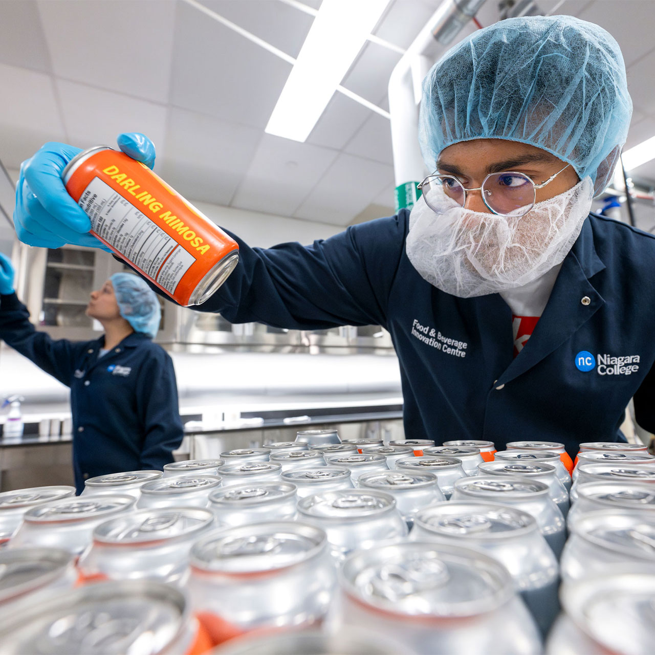 Student in blue lab coat test NC beer