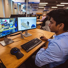 Student works on CAD models on a computer