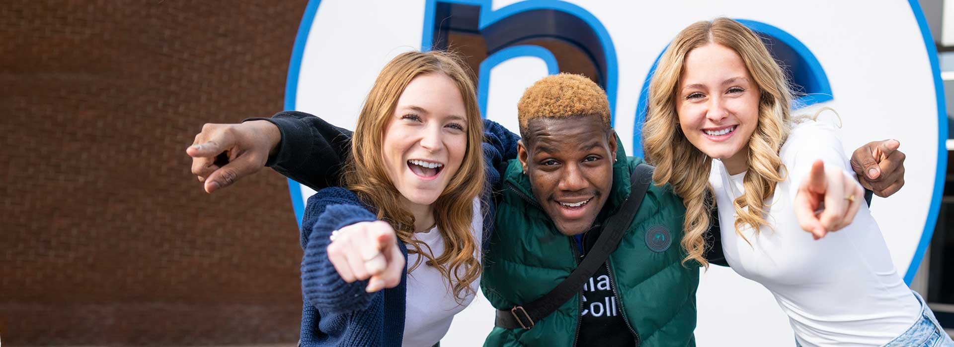 Three students posing outside at Welland campus