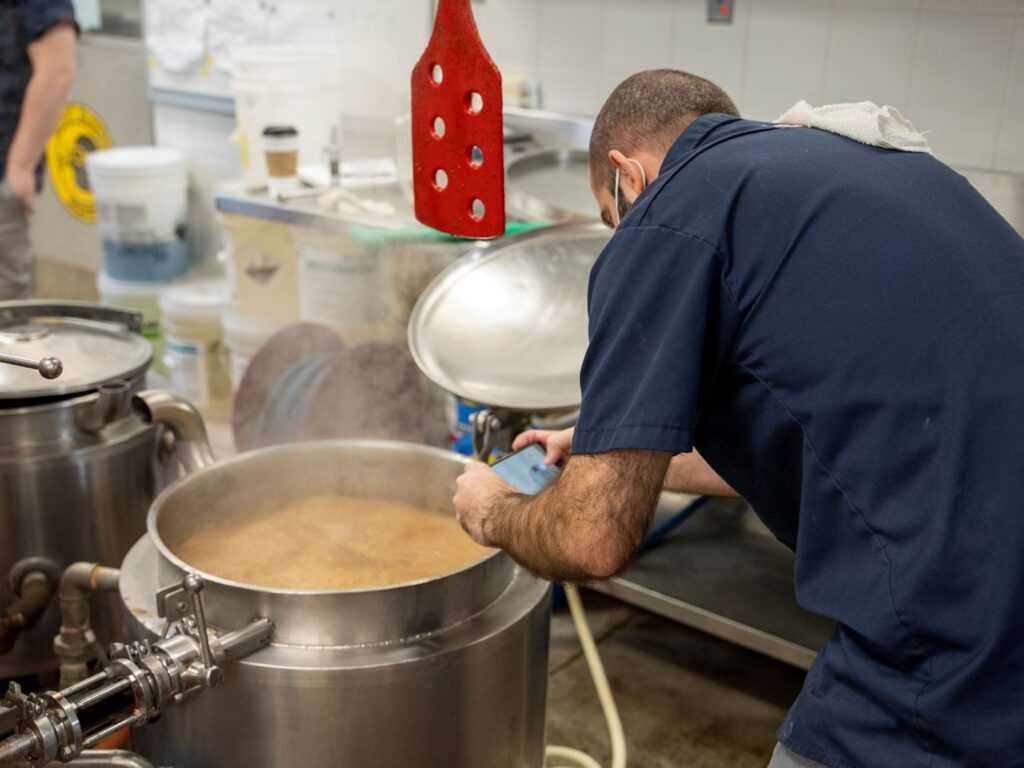 a student checks on his beer in the Teaching Brewery