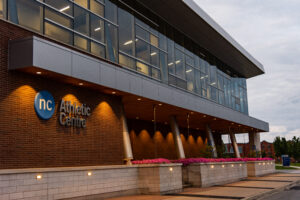 Modern architecture of the Welland Campus Athletic Centre from the front, illuminated at dusk